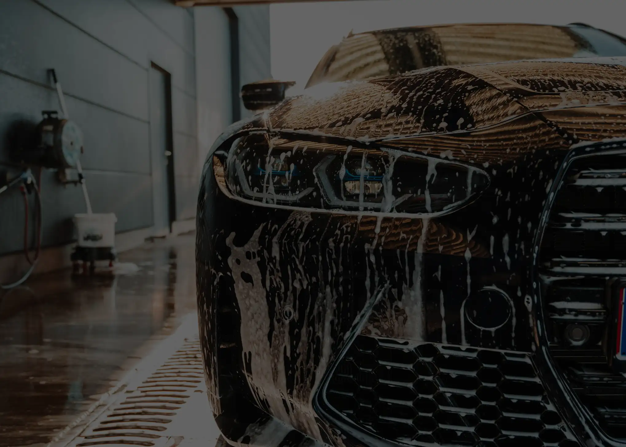 Eco-friendly hand washing a vehicle with biodegradable foam at Clyde Hand Car Wash and Detailing, Clyde North